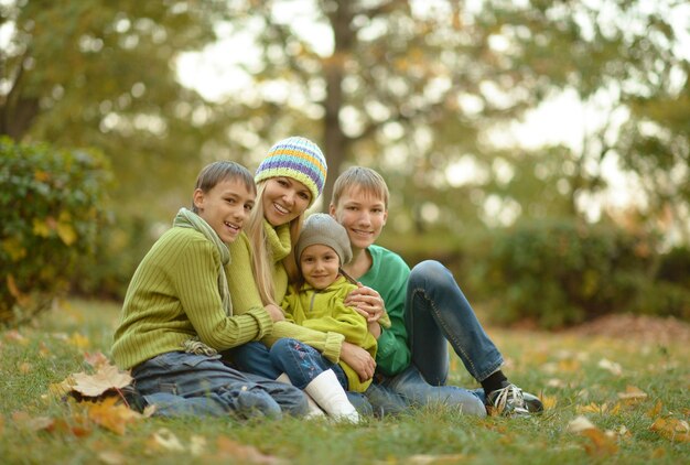 Famiglia sorridente felice che si rilassa nel parco d'autunno