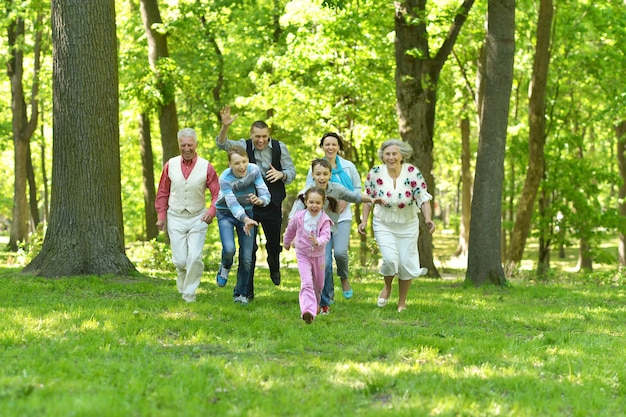 Happy smiling family run in a forest