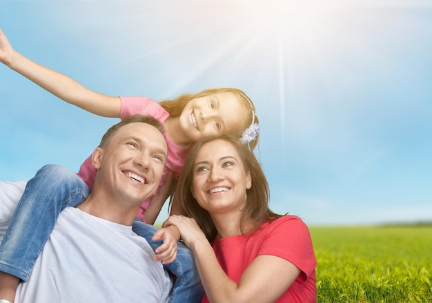 Happy smiling family with daughter on park background