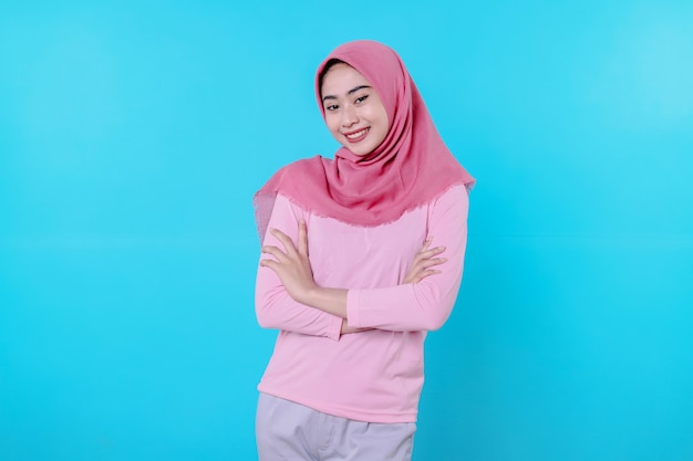 Happy smiling female with attractive appearance and wearing hijab, pink t shirt showing smile good mood