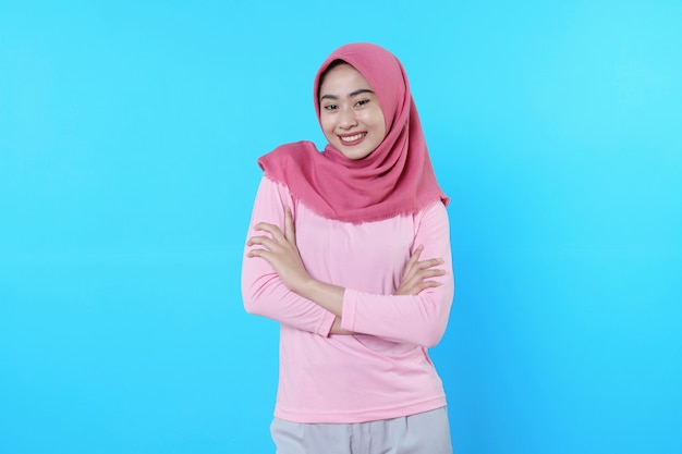 Happy smiling female with attractive appearance and wearing hijab, pink t shirt showing smile good mood