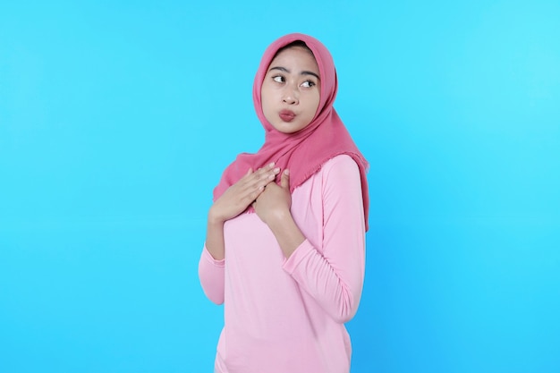 Happy smiling female with attractive appearance and wearing hijab, pink t shirt showing smile good mood