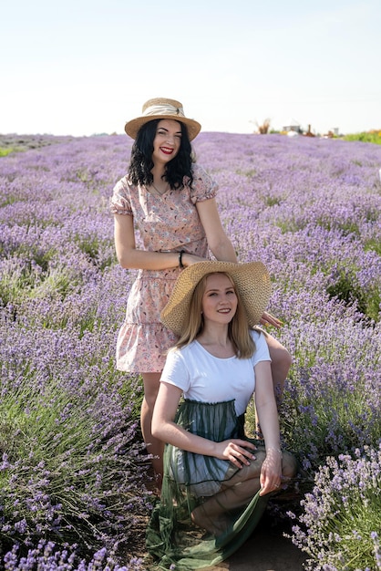 Happy and smiling friends in sunlight in lavender field