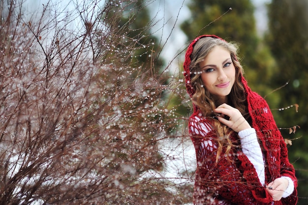 The happy smiling girl in the winter 