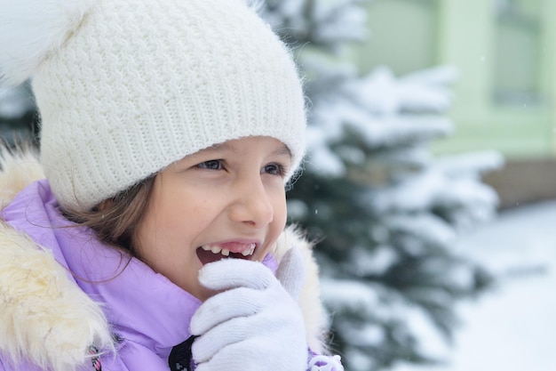 Happy smiling little girl posing outdoor in winter