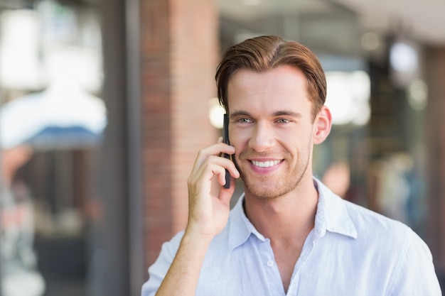 A happy smiling man calling