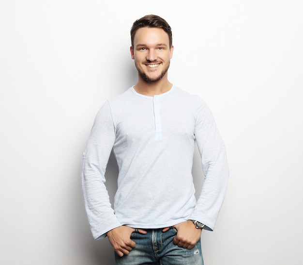 Happy smiling man looking at camera on white background