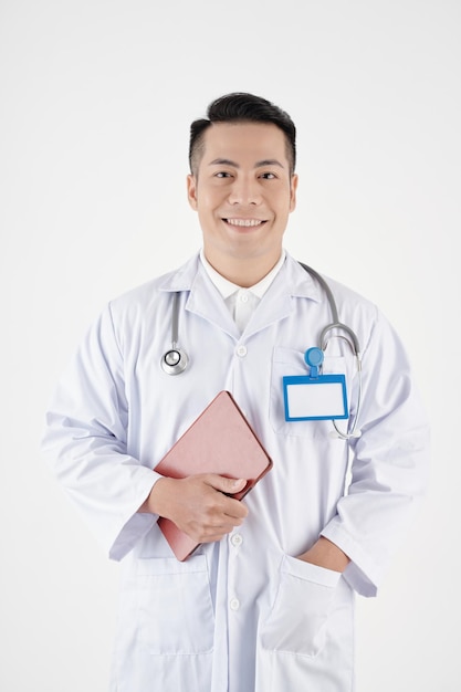 Happy smiling middleaged general practitioner holding digital tablet and looking at camera