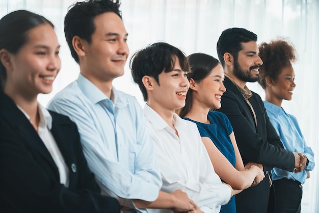 Happy and smiling multiracial office worker hold hand in a line promoting synergy and collaboration for business success Diverse professional office worker bond at modern workplace Concord