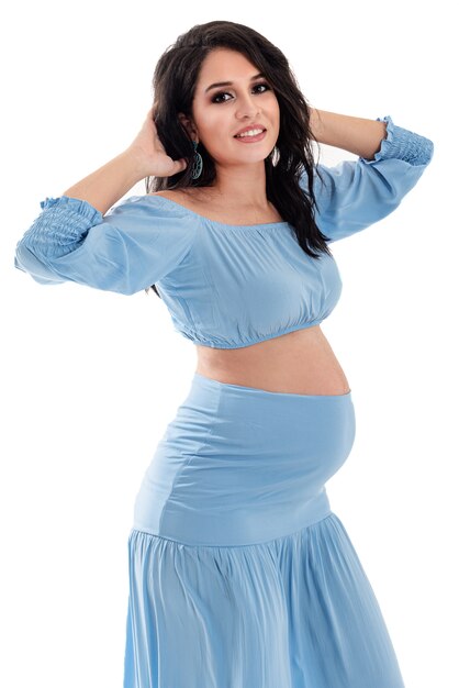 Happy smiling pregnant woman touching her belly isolated on white background