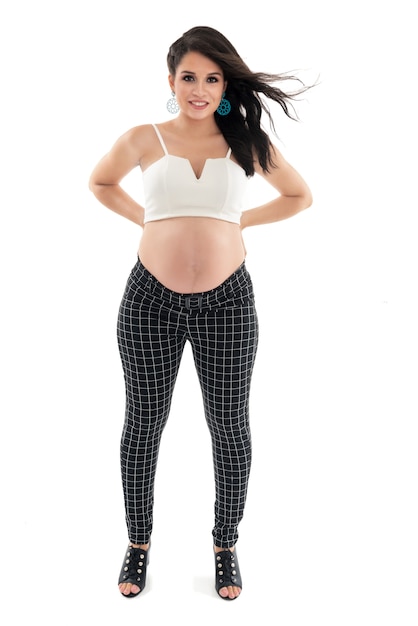 Happy smiling pregnant woman touching her belly