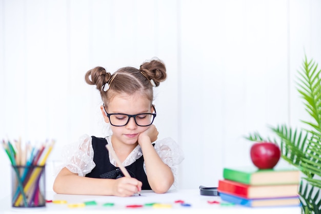 Happy smiling pupil at the desk