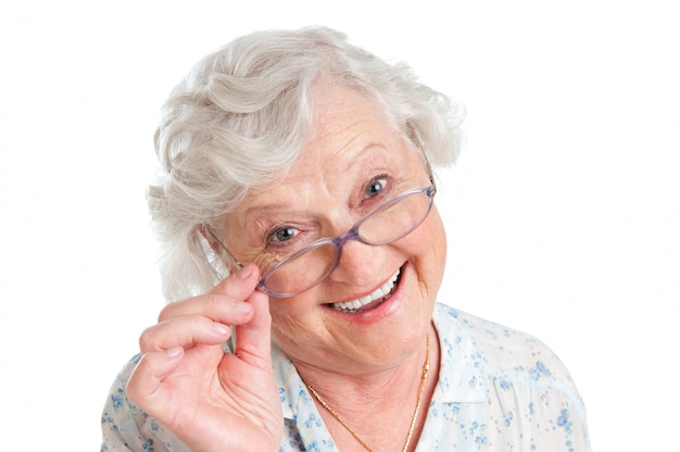 Happy smiling retired lady wearing her new pair of glasses isolated on white 