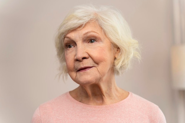 Happy smiling senior woman looking away at home Old senior woman portrait Retirement people concept Stock photo