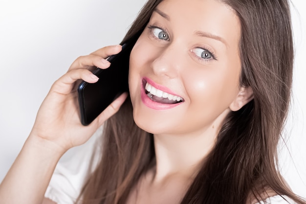 Happy smiling woman calling on smartphone portrait on white background people technology and communication concept