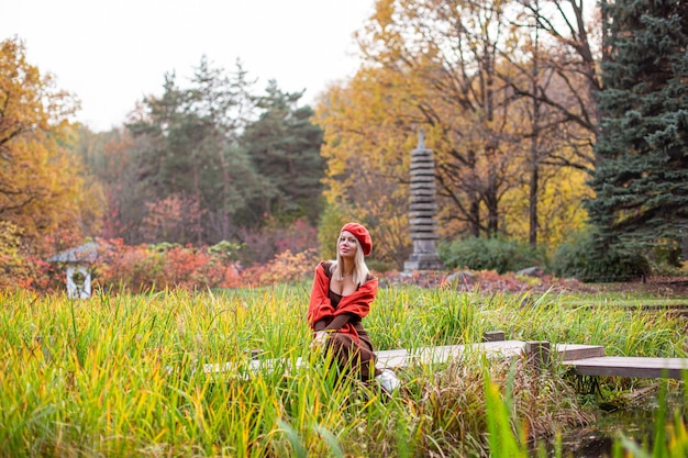 Happy smiling woman holding in her hands yellow maple leaves