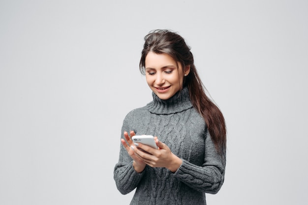 Happy smiling woman using smartphone