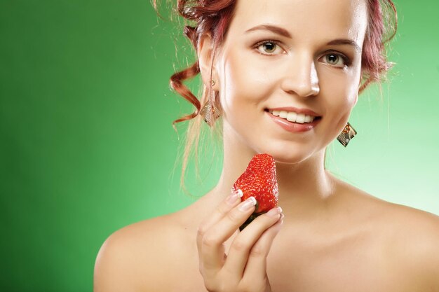 Happy smiling woman with strawberry