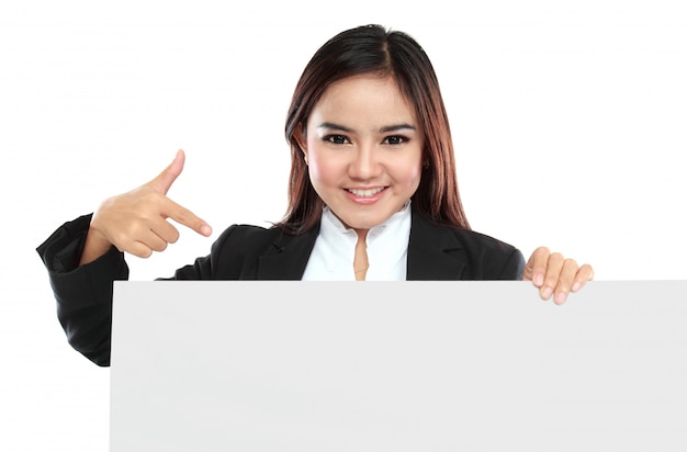 Happy smiling young business woman showing blank signboard