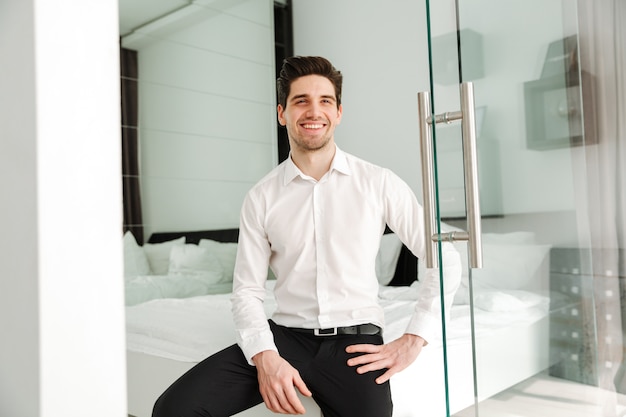 Happy smiling young businessman indoors