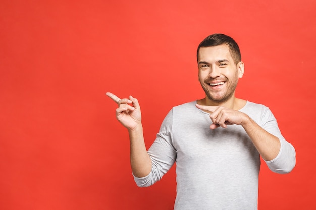 Happy smiling young man presenting and showing