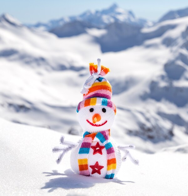 Happy snowman in mountains