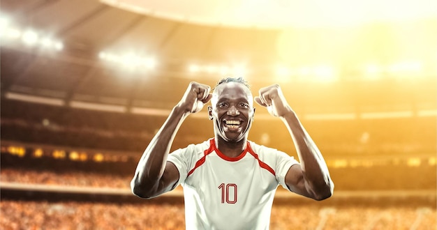 happy soccer player celebrate a victory on a professional football stadium