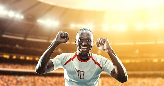 happy soccer player celebrate a victory on a professional football stadium