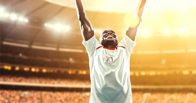 happy soccer player celebrate a victory on a professional football stadium
