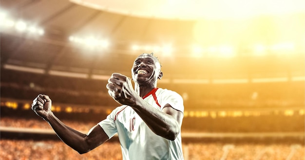 happy soccer player celebrate a victory on a professional football stadium