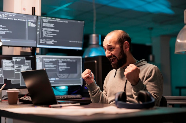 Happy software developer celebrating coding achievement,\
feeling pleased about app programming success after hours in\
office. cheerful smiling coder enjoying victory, coding\
script.