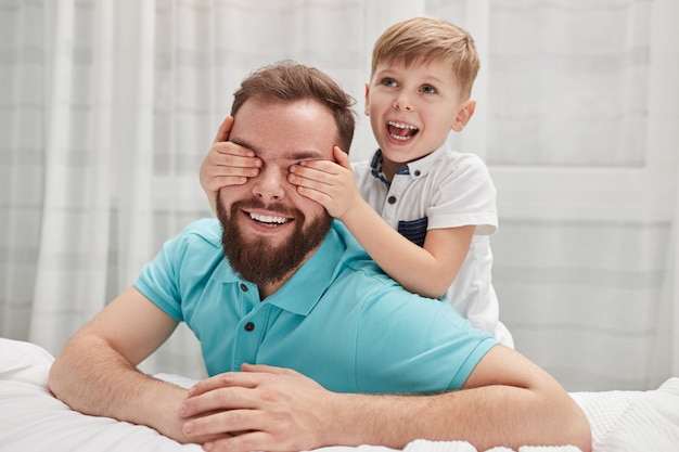 Happy son making surprise to father