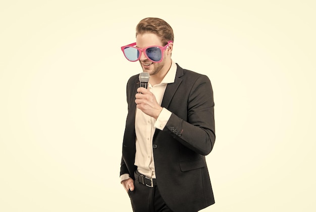 Happy speaker man in funny glasses and formal suit speak to microphone conferencier