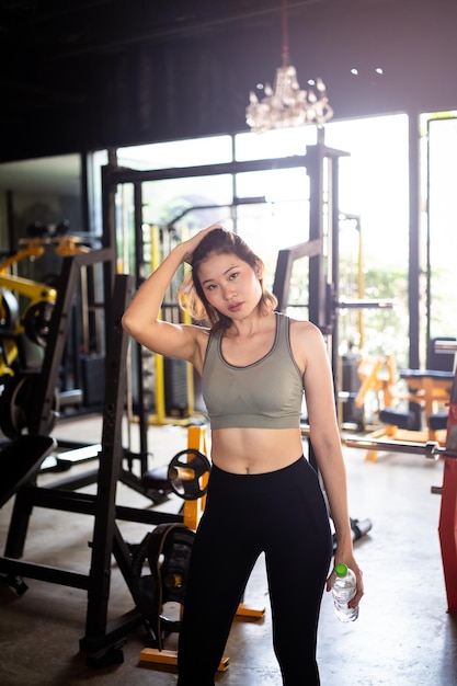 Happy sport women exercise drink water workout smile training at the gym athlete girl training strong and good health and strength Fitness sport concept