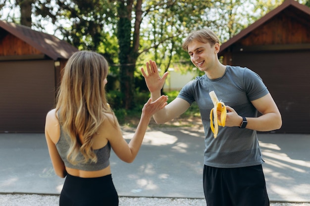 Happy sports couple eating healthy food after workout