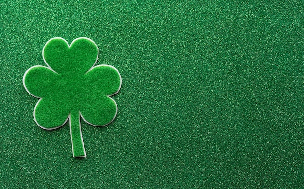 Happy St Patrick's Day decoration concept made from shamrocks clover leaf on green background