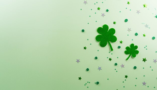 Happy St Patricks Day decoration concept made from shamrocks clover leaf on green pastel background