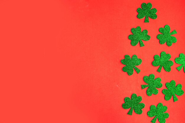 Happy St Patricks Day Shamrocks pattern on bright orange background Copy space for the text