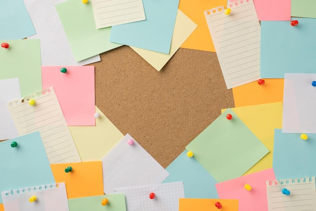 Happy St Valentines day concept. Photo of stack of multicolored stickers attached to the board making heart with blank empty space inside