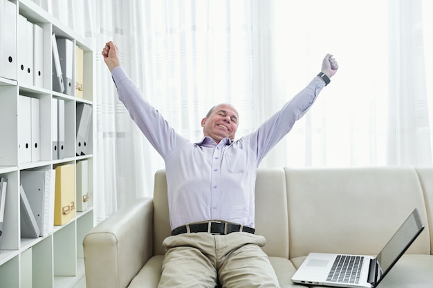 Happy stretching businessman