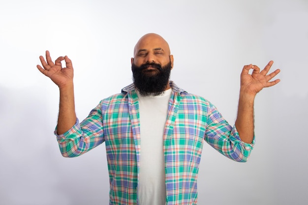 Happy Strong Healthy bald guy doing yoga exercise meditating closed eyes make fingers mudra gesture