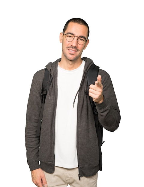 Happy student pointing at you with his finger