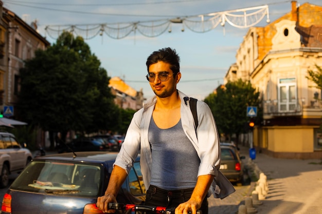 The happy student rides an electric scooter in the city