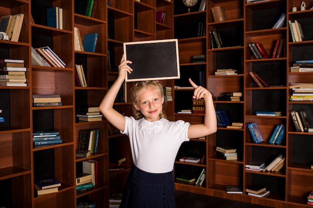 Happy student with an empty slate books