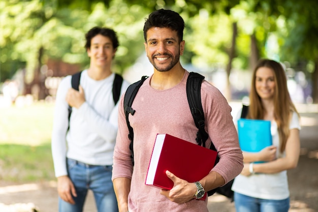 Happy students outdoor smiling confidently