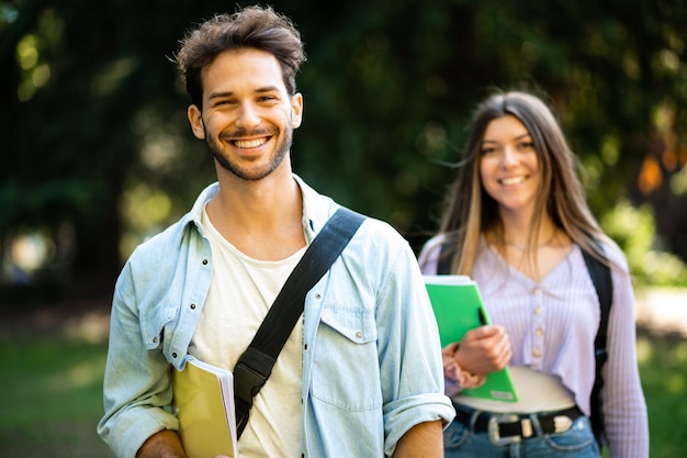 Happy students outdoor smiling in a hot sunny day