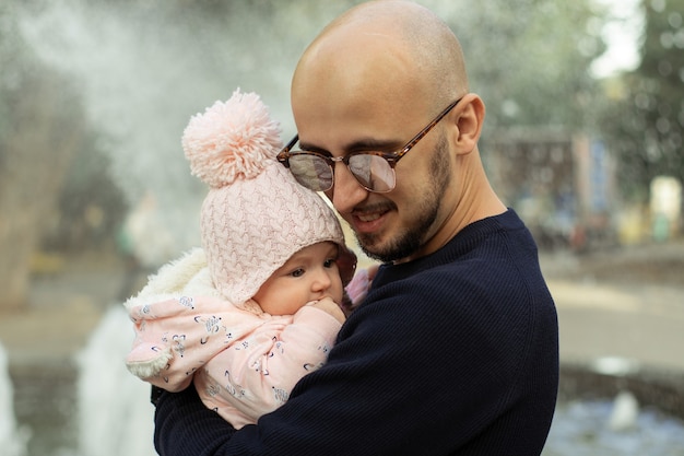 Happy stylish father with his little baby girl