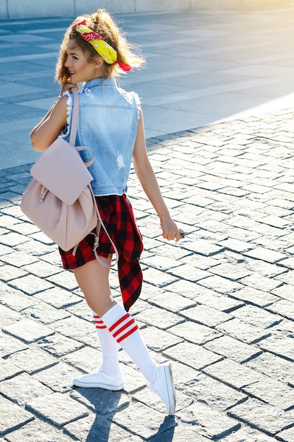 Happy stylish teenage girl with backpack