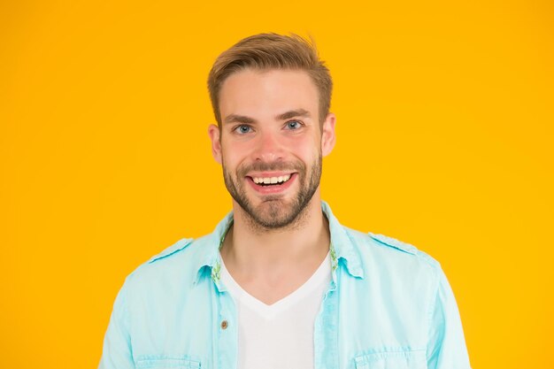 Happy stylish unshaven man wear casual shirt on yellow background male beauty