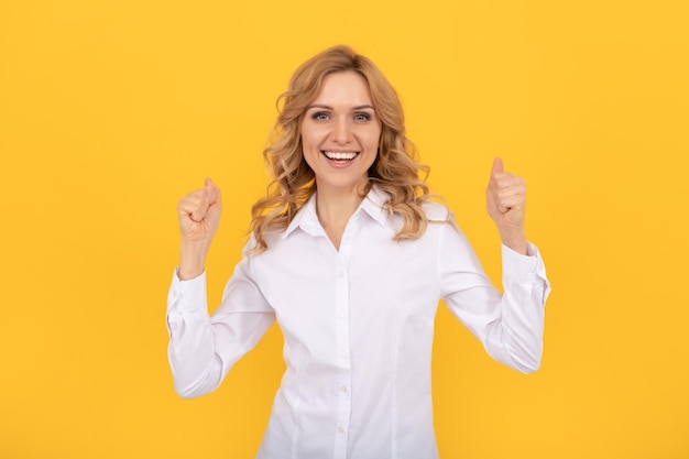 Happy successful businesswoman woman in white shirt hold thumb up success